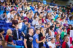 Blurred crowd of spectators on a stadium tribune at a sporting event photo