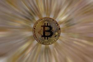 New shiny silver bitcoin coin with golder bitcoin b symbol on golden glitter background with copy