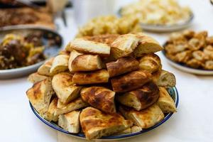 loaf of pitta bread on wooden table photo