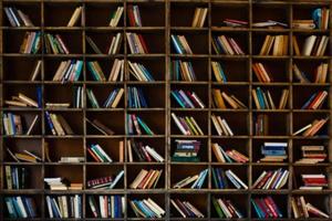 Blurred image many old books on bookshelf in library photo