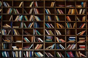 Blurred image many old books on bookshelf in library photo