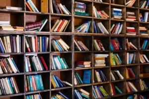 Bookshelf in library with many old books photo