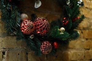 Home made holiday wreath hanging on stone wall. photo