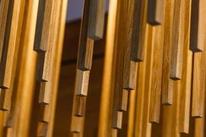 texture of wooden sticks hang from the ceiling at outdoor constructions photo
