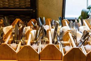 The forks and knives in a wooden stand photo