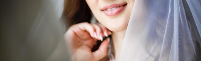 Lips and bride s hand with a ring with pebbles and manicure photo