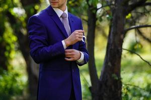 Handsome groom in suit  the nature male portrait  the park beautiful model boy  colorful photo