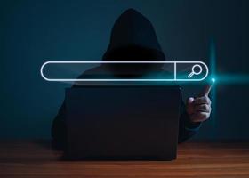 Hackers work on laptops in the dark. The concept of information security in the Internet network and information espionage. photo