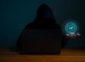 Hackers work on laptops in the dark. The concept of information security in the Internet network and information espionage. photo