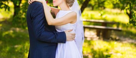 Happy bride and groom at a park on their wedding day photo