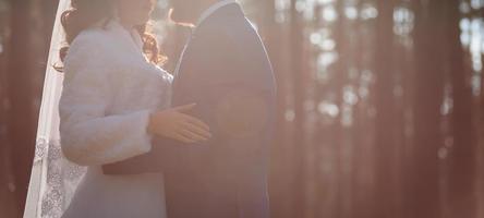 Sunshine portrait of happy bride and groom outdoor in nature location at sunset warm summertime photo