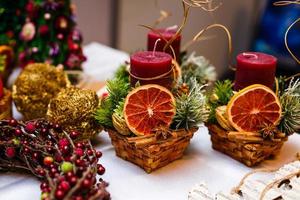 Candles Christmas decor with spices citrus fruits photo