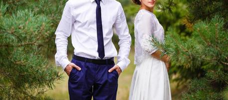 Newlyweds groom and bride walking in autumn park photo