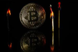 Golden bitcoin on black background with copy space cryptocurrency mining concept burns photo
