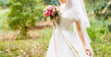 Wedding bouquet in bride s hands photo