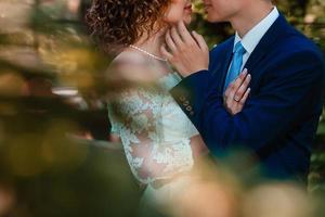 Happy bride and groom at a park on their wedding day photo