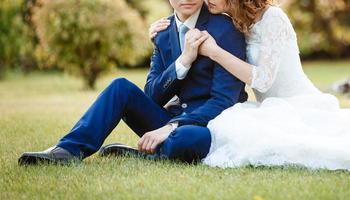 Happy bride and groom at a park on their wedding day photo