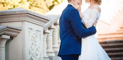 Portrait of happy bride and groom near columns photo