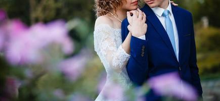 Happy bride and groom at a park on their wedding day photo