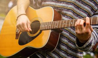 Man plays the guitar on the street retro style photo