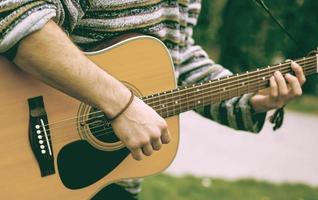 Guy play guitars in city park outdoor photo