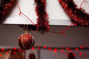 Shiny Christmas red ball hanging on pine branches with festive background photo