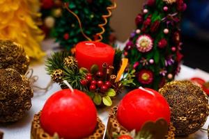 Candle decorated with cinnamon sticks and red apples, christmas decoration photo