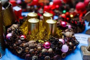 Christmas decorations, candle, nuts, cones, cinnamon, apples, star on a wooden background. Holiday mood. photo