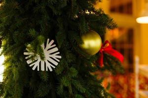 decoración navideña con copos de nieve en el árbol de navidad y fondo claro bokeh. foto