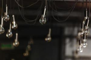 Old light bulb lamp with spider web hang on thatch roof. photo