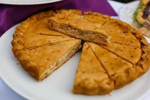 meat pie sliced on a white plate photo