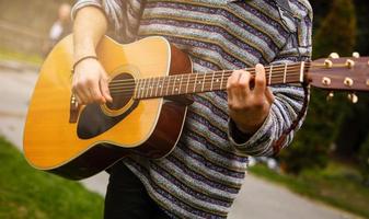 Man plays the guitar on the street retro style photo