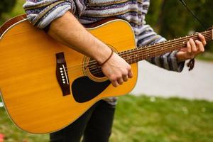 Man plays the guitar on the street retro style photo