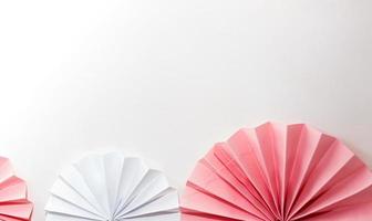 Pink and white striped paper fans photo