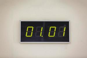 Black digital clock on a white background showing time  01.01 January st day of month calendar winter time new year concept empty photo