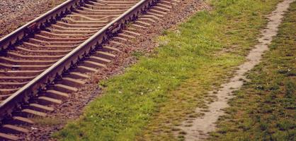 Two railway tracks merge photo