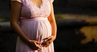 Silhouette of pregnant woman in the sunset photo