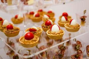 Close up view. Catering buffet table with a delicious food. Tartlets with cream cheese salad photo