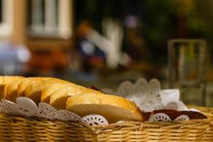 Pieces of white bread in a basket on a table photo