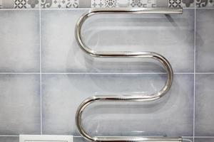 Modern bathroom towel dryer polished steel and chrome photo