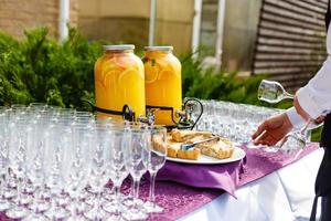 Bank of lemonade with citrus fruits on a buffet table photo