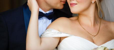 Just married couple dancing valse outdoor, free space. Bride and groom hugs, blurred green grass background. First wedding dance concept photo