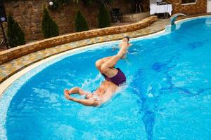 Man diving in private swimming-pool photo