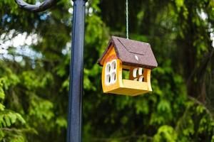 knitted from yarns birdhouse hanging in the park photo