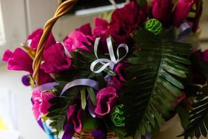 An outside basket filled with vibrant multicolored petunias flower. photo