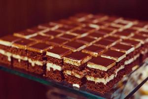 Selection of decorative desserts on a buffet table at a catered luxury event or celebration photo