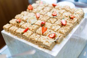 mini cakes with chocolate and strawberries photo