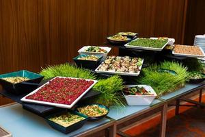 people group catering buffet food indoor in luxury restaurant with meat colorful fruits and vegetables photo
