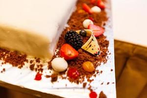 The summer biscuit naked bargaining with cream of mascarpone and fresh berries on a wooden background. photo