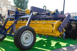 Agriculture equipment concept. Detailed closeup agricultural machinery, big wheels with tires. Outdoor shot photo